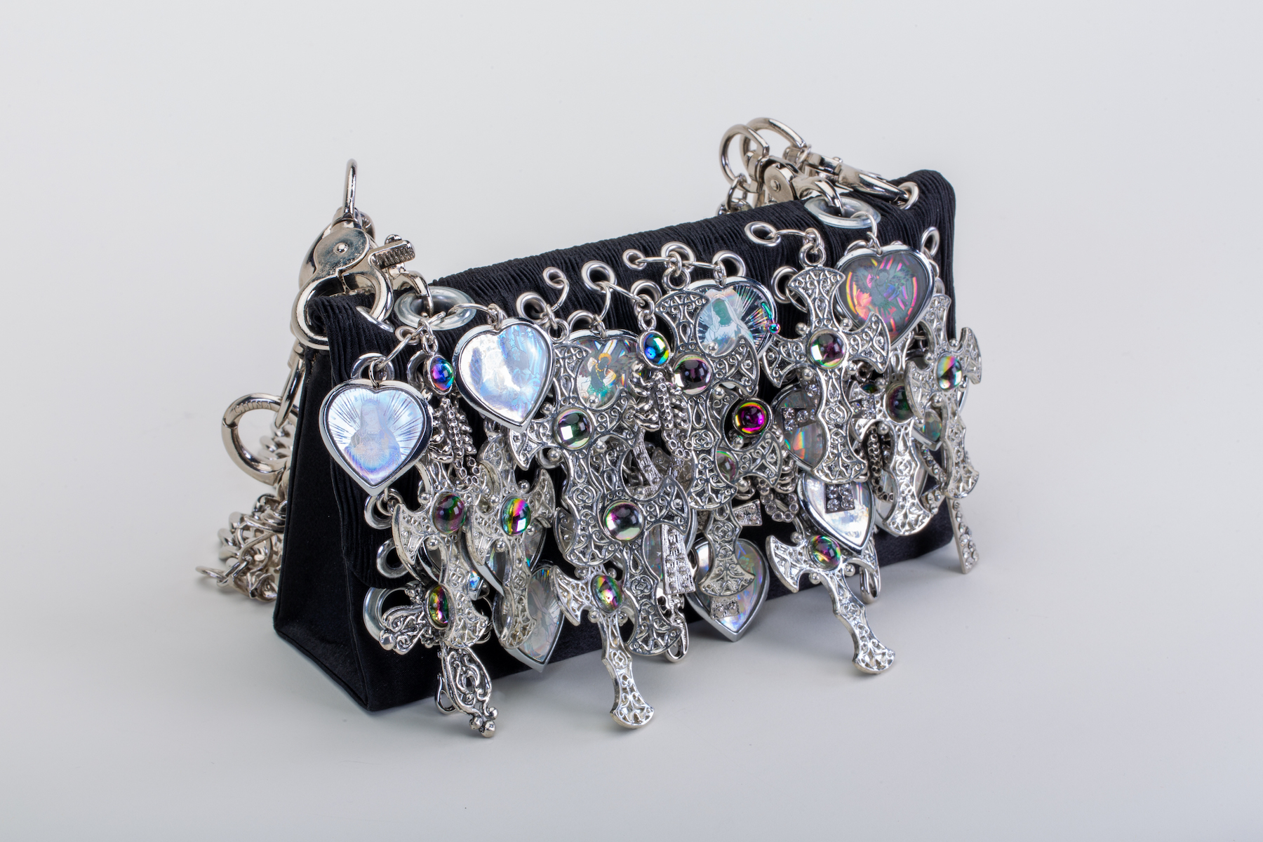 Trevino Sacred Purse A black purse bedazzled with many, many silver crosses and some hearts.