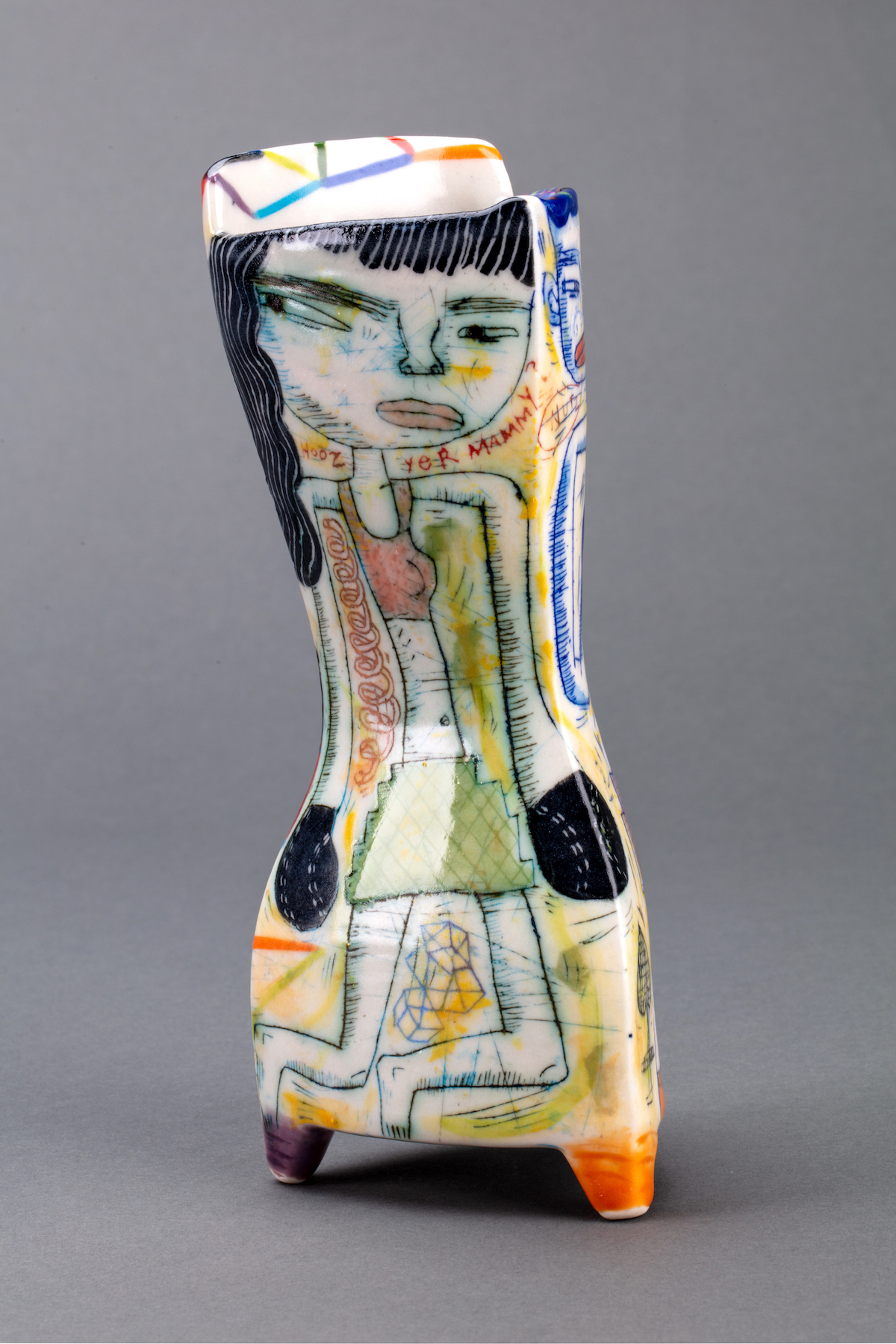 Ceramic vase-like structure. Characters are shown on all sides along with text through careful glazing.