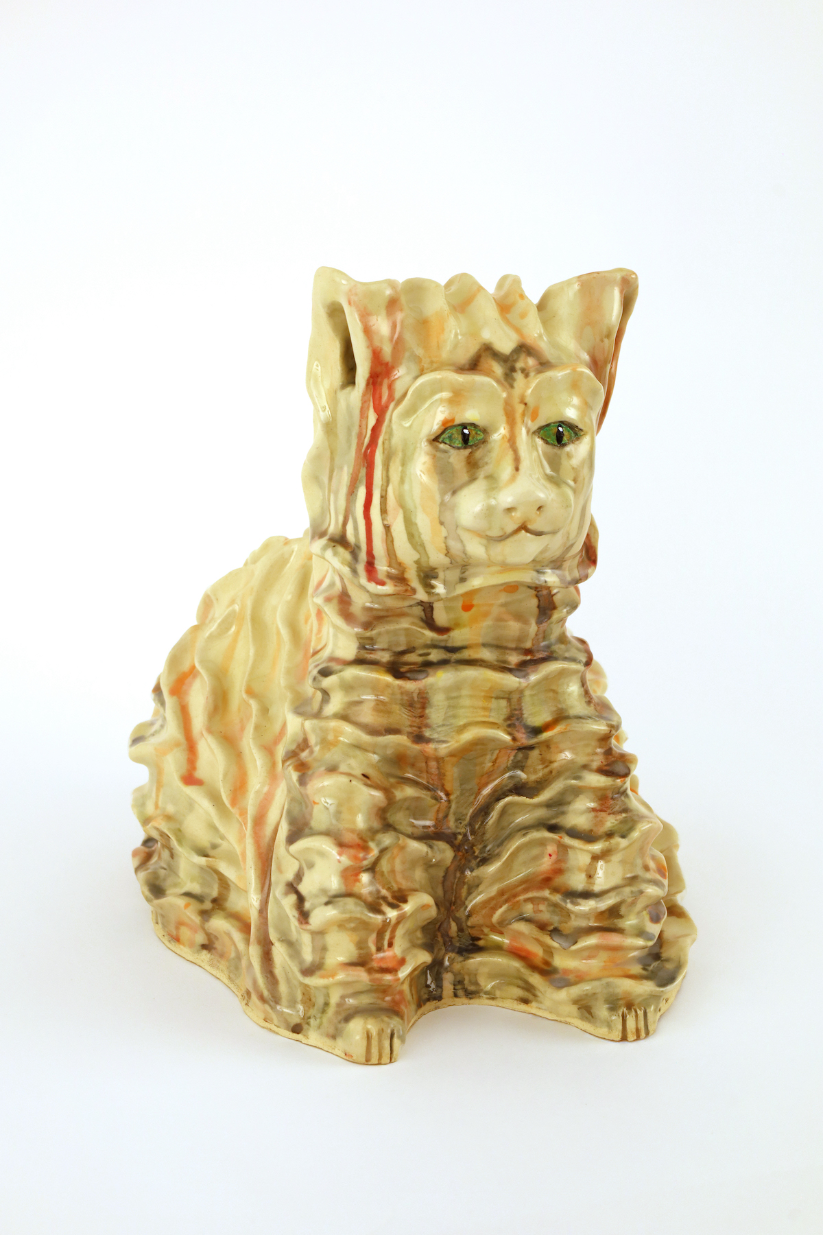 Samantha Nelson, The Cat A sculpture of a cat. It has many waves and layers but uses minimal color. It mainly has an earthy sand with dripping streaks of red, brown, and orange.