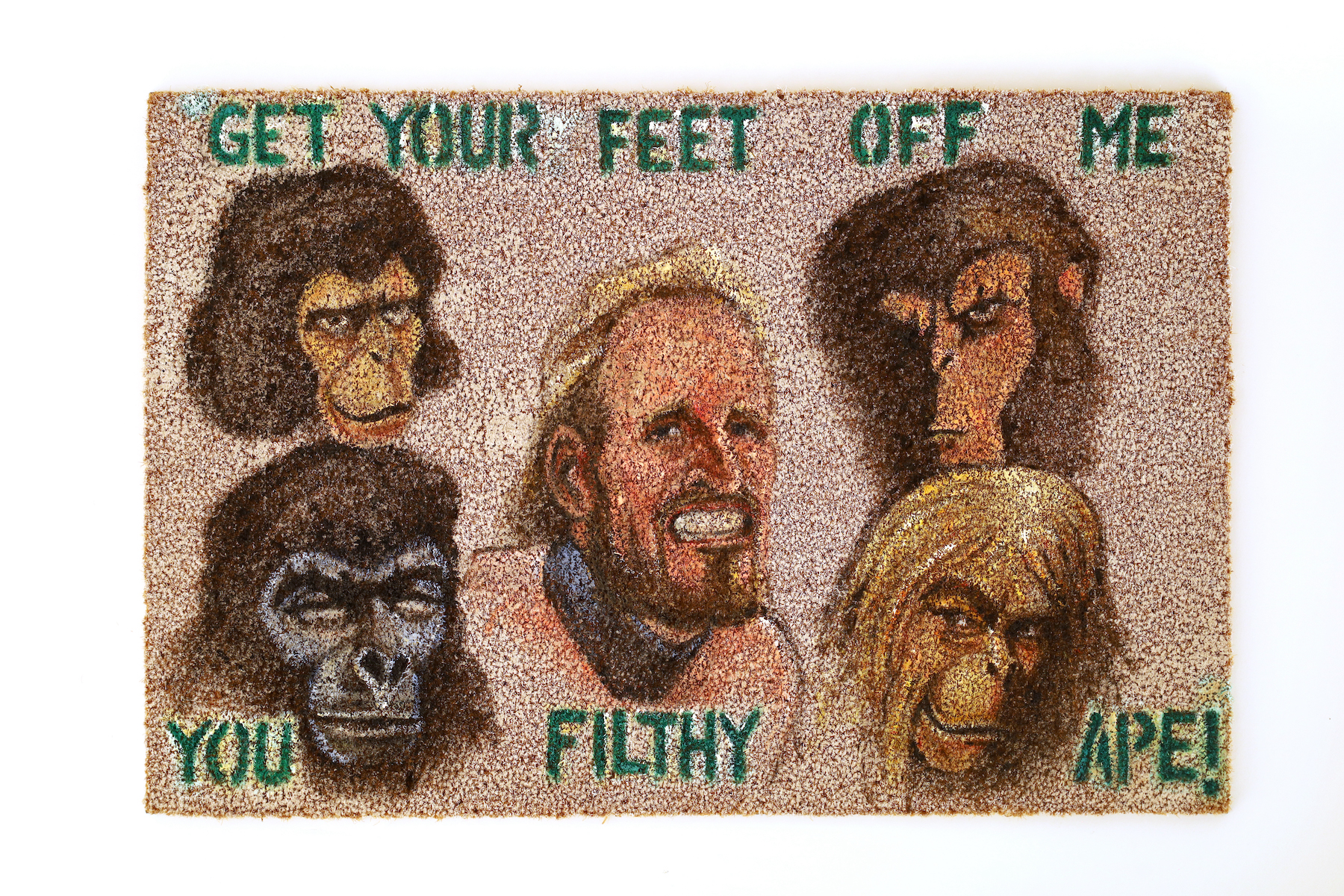 Alexander Greiveldinger, Welcome Mat to the Planet of the Apes A welcome mat with five different kinds of apes' faces, including a human. It reads "GET YOUR FEET OFF ME YOU FILTHY APE!"