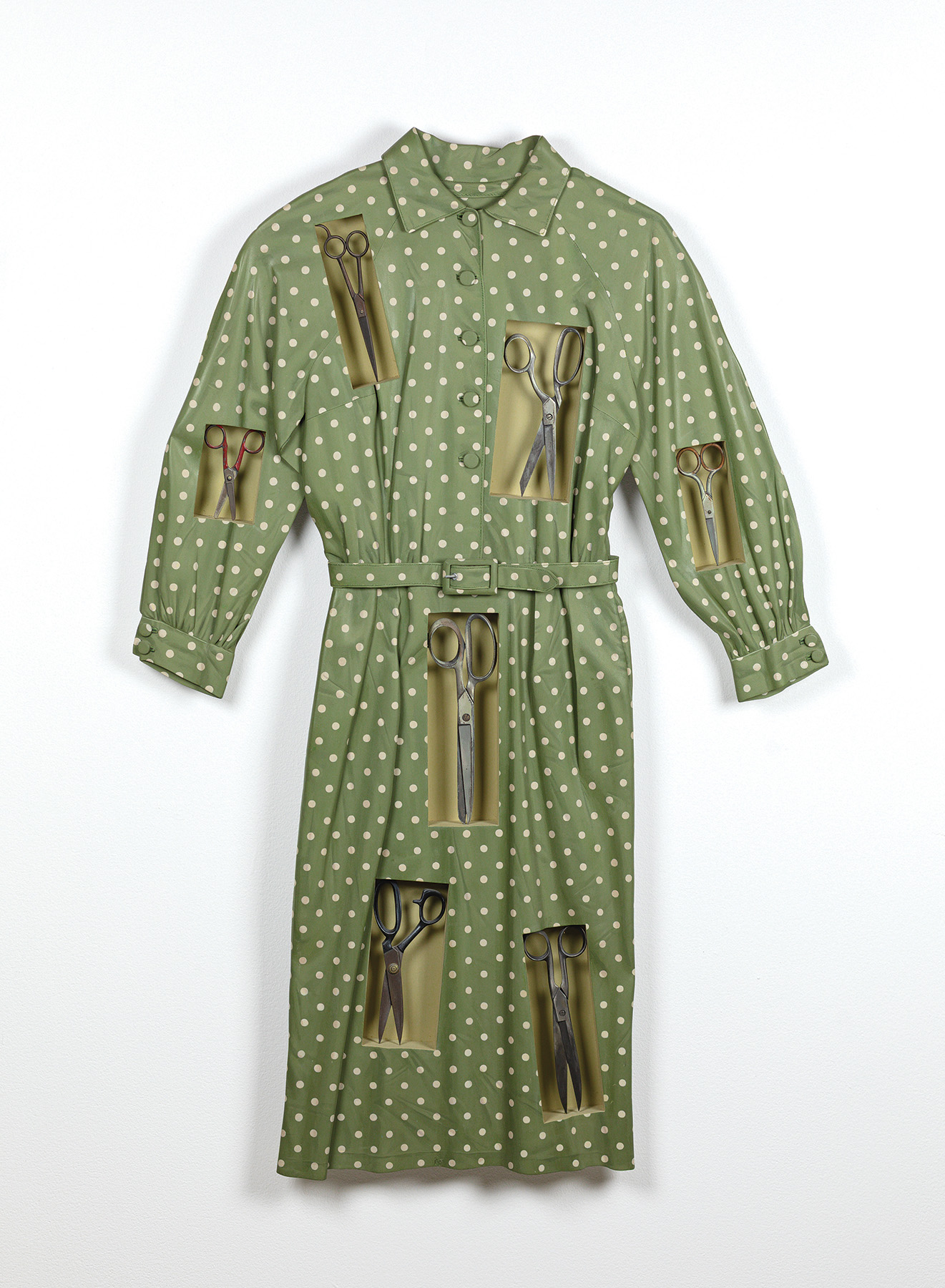 Ron Isaacs, Improve Each Shining Hour A green polka dot dress with rectangles cut out of it. Each rectangle cutout has a pair of scissors revealed inside the clothes.