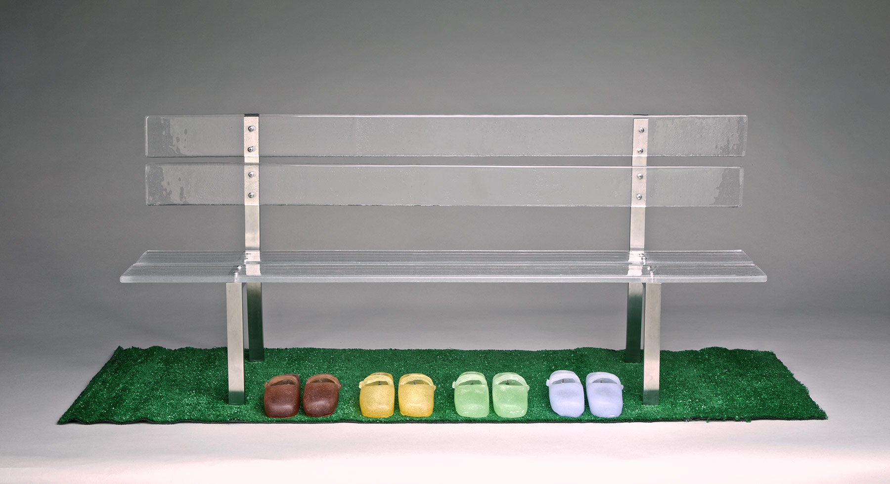 Silvia Levenson, Panchina Di Vetro (Bench of Glass) Metal and glass bench and four multicolored pairs of glass shoes atop AstroTurf grass