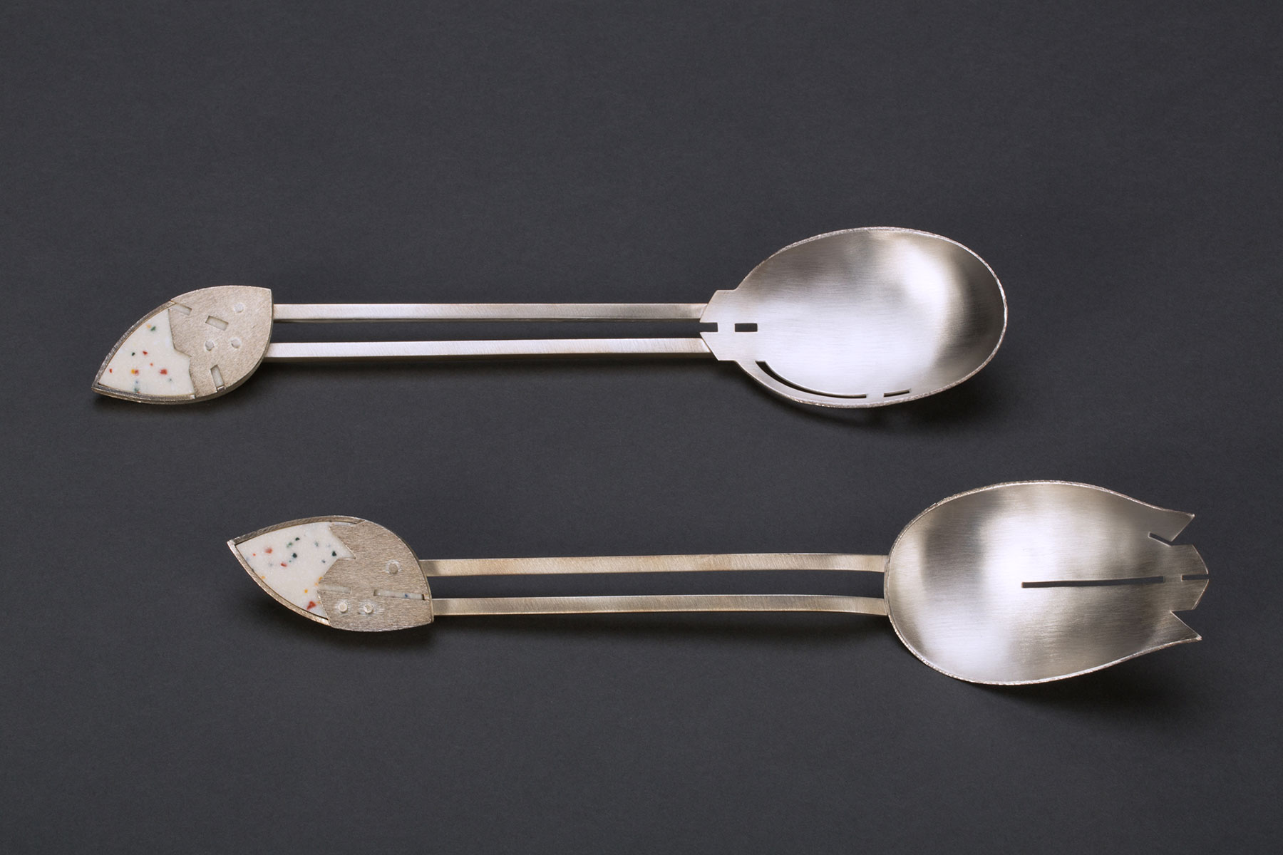 Terri Gelenian-Wood, Salad Servers Two silver salad servers—one rounded and one jagged—with an eyeball-shaped adornment at the end